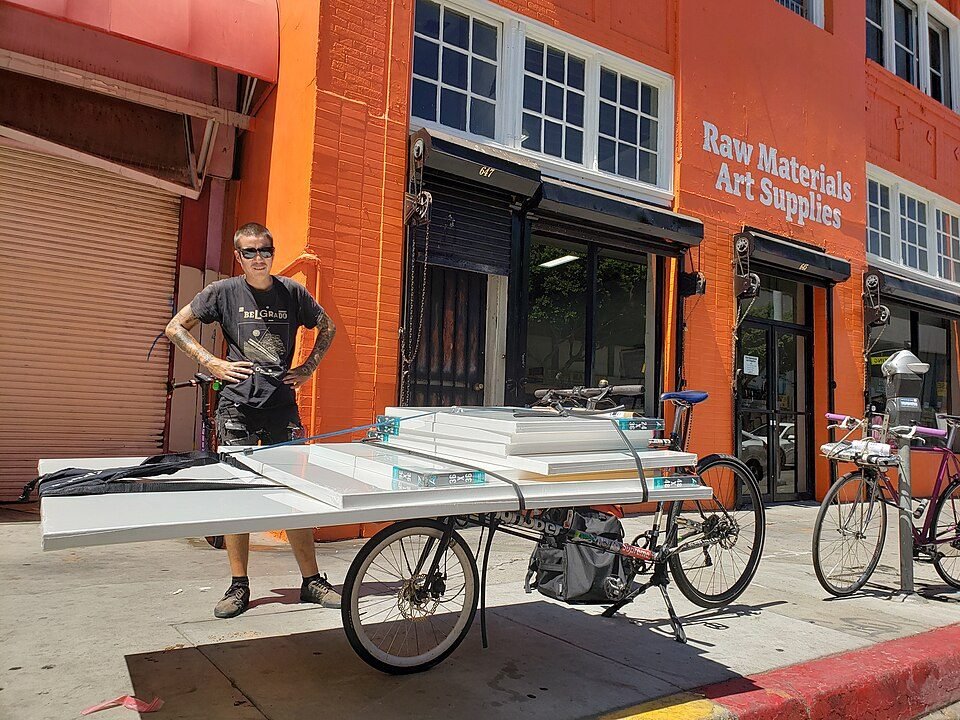 Courier loading a cargo bike in the city